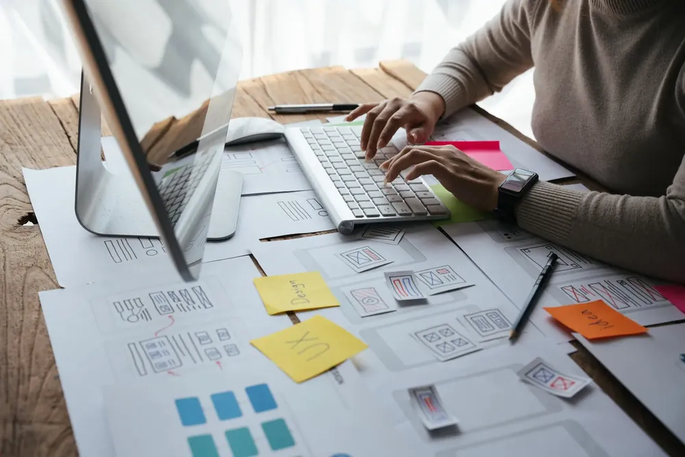 Person working on website design at their desk