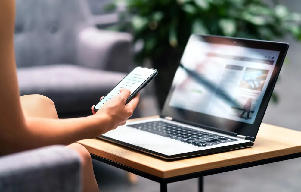 Woman viewing their website on a laptop and phone